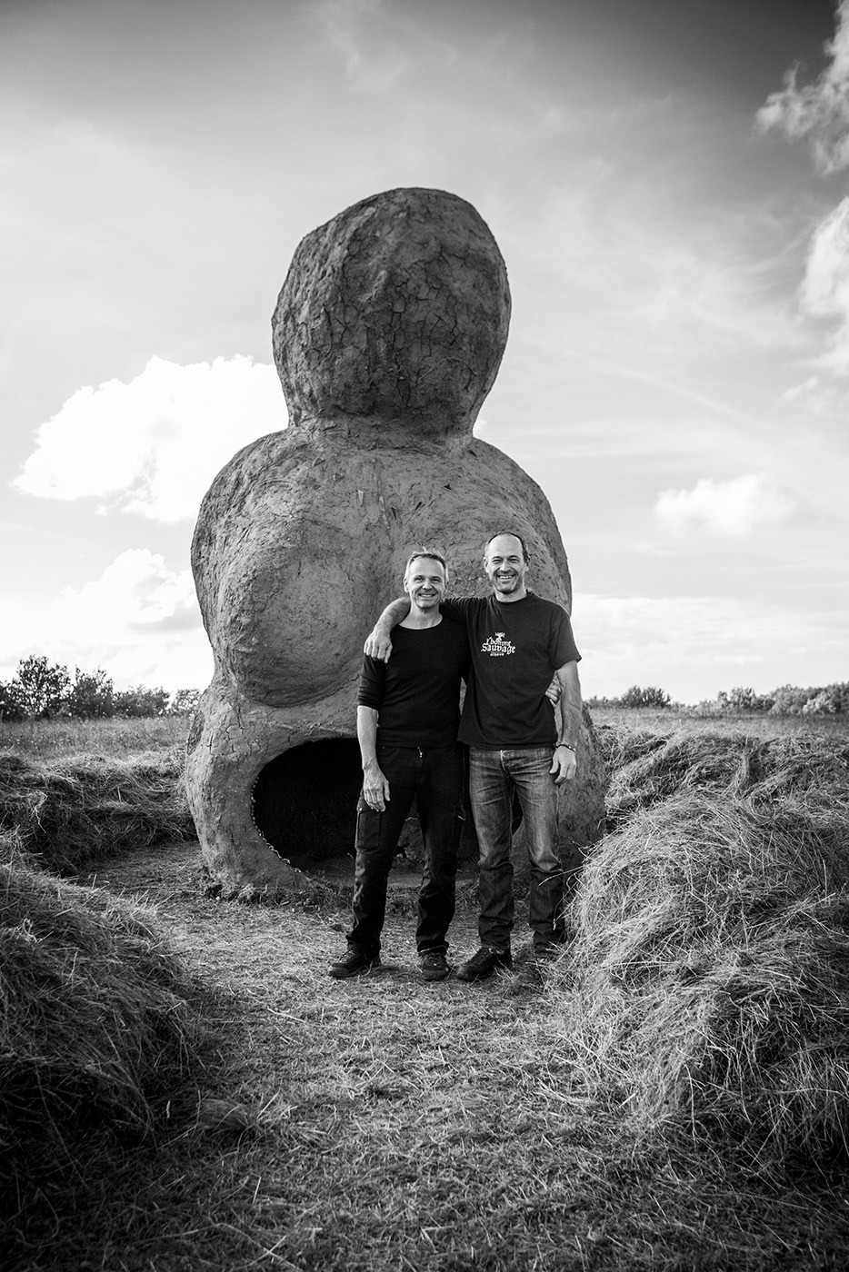 Photographie de Yan Arexis, fondateur de l'Homme sauvage, avec Alexandre Drabzak, créateur de la Vénus (œuvre monumentale en torchis) en arrière plan..