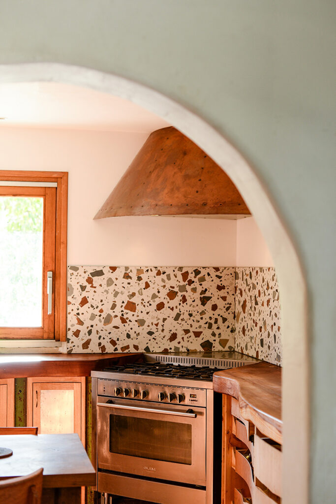 Vue de la hotte de loin, avec en premier plan une arche marquant le passage dans la cuisine.