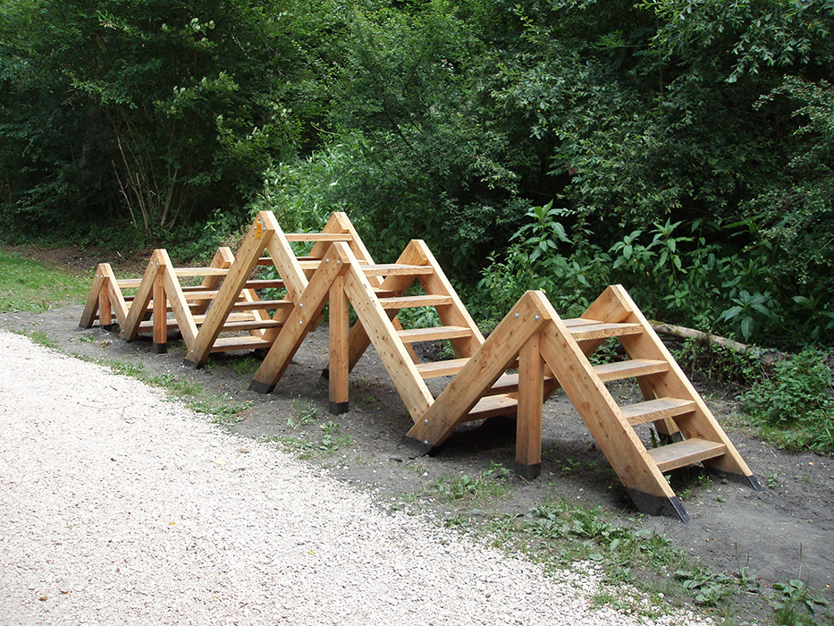Agrès en bois destiné à un exercice de type "cardio", constitué d'une escalier en montagne russe, appelé "montagne lilliputienne". Dispositif innovant imaginé, conçu et réalisé par Alexandre Drabzak, et appartenant à un ensemble constituant un parcours sportifs de plein nature.